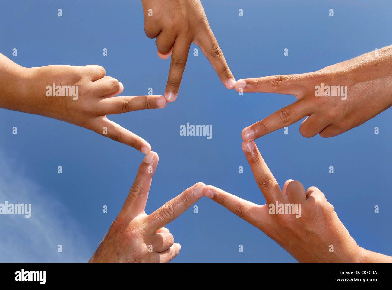 Hands together forming a star Stock Photo - Alamy