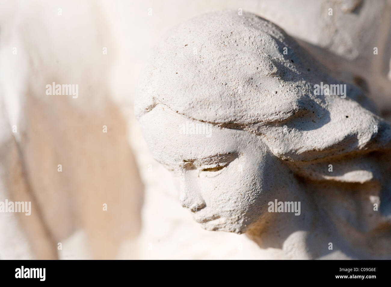 Female head from a concrete garden statue ornament. Stock Photo