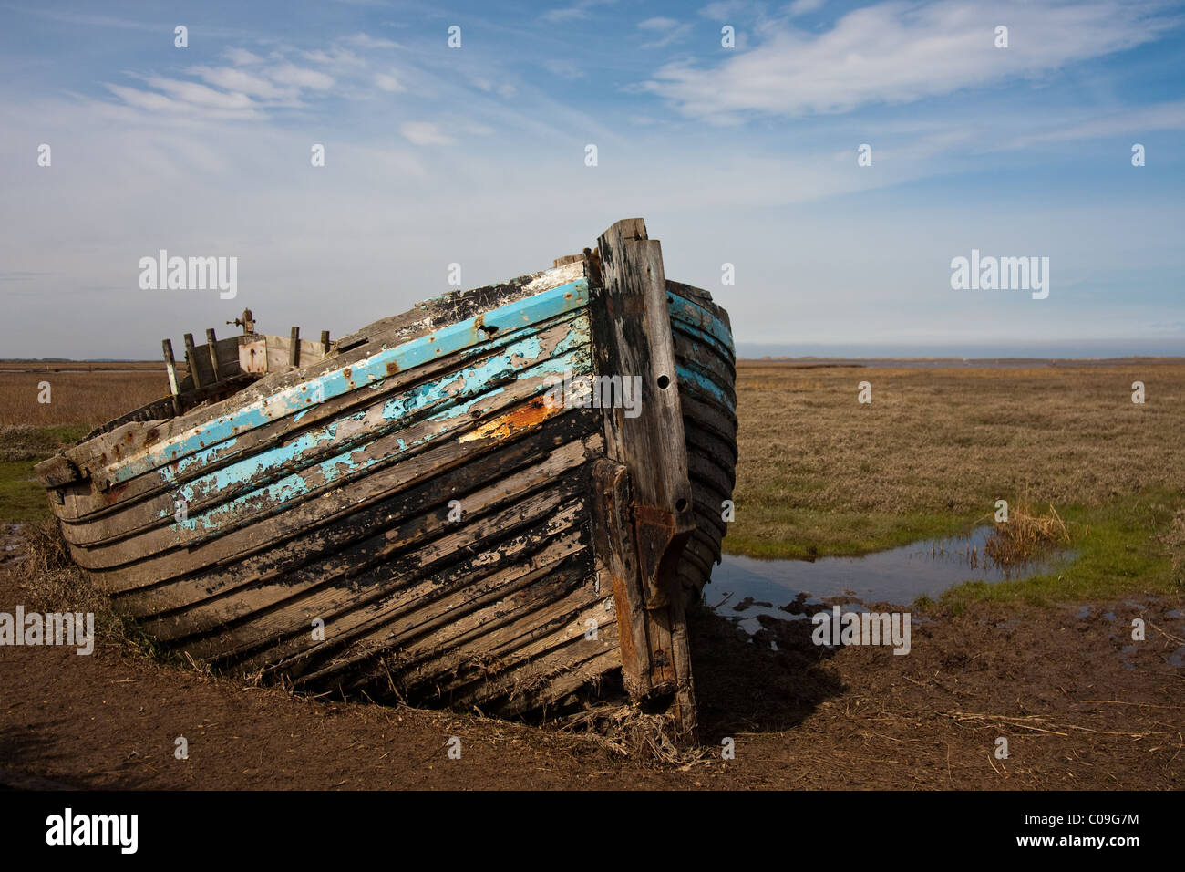 Picture of a wrecked wooden boat from front view on marshes at Blakeney in Norfolk. Stock Photo