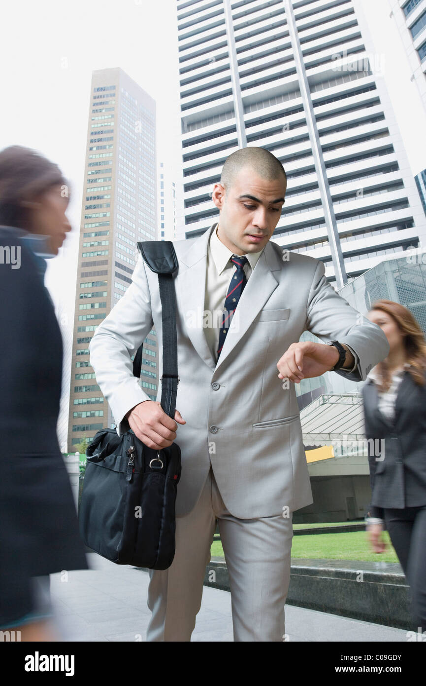 Businessman checking the time Stock Photo - Alamy