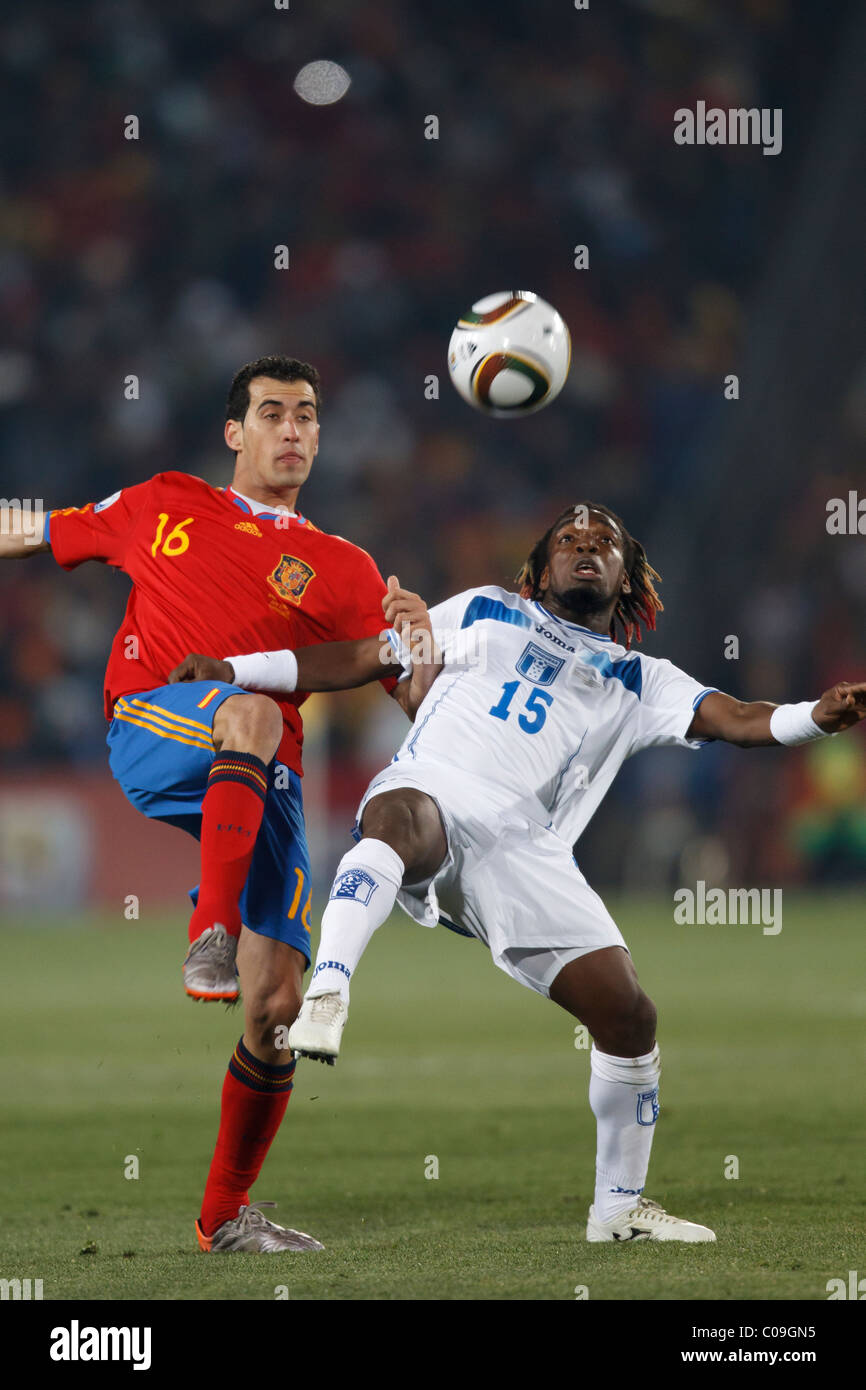 Sergio Busquets of Spain (16) and Walter Martinez of Honduras (15) vie for the ball during a 2010 FIFA World Cup Group H match. Stock Photo