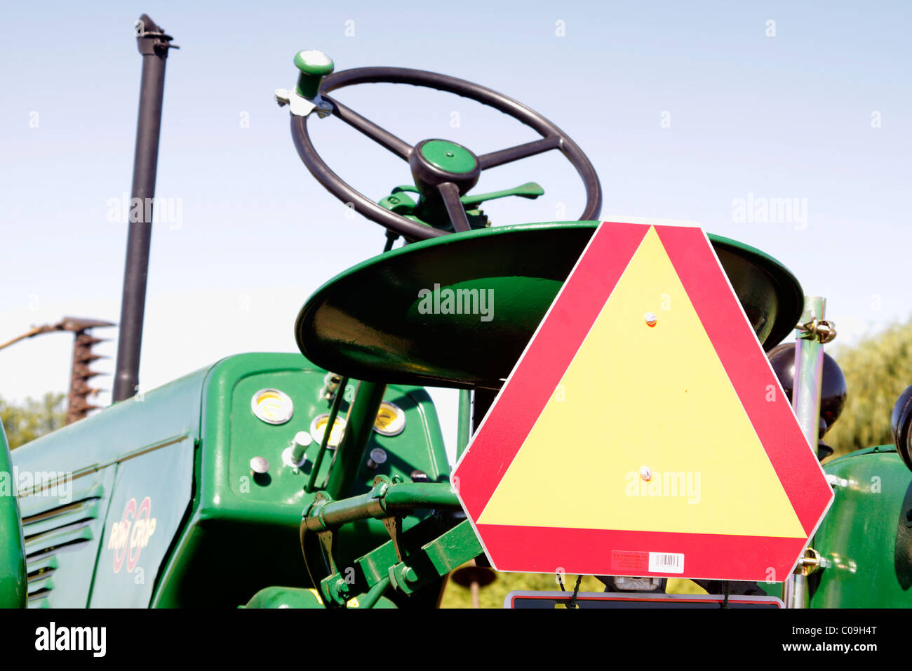 Slow moving vehicle sign on old tractor Stock Photo - Alamy