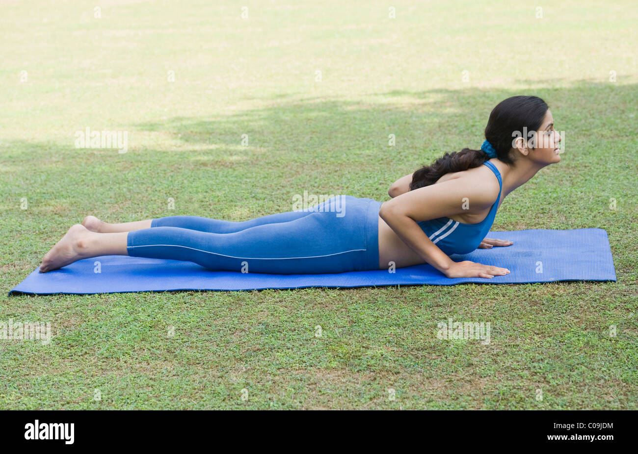 Woman doing Surya Namaskar (Sun Slautation) Stock Photo