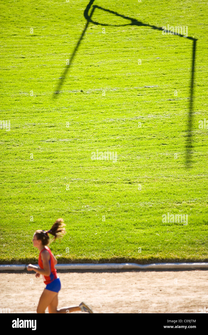 Girl running around track Stock Photo Alamy
