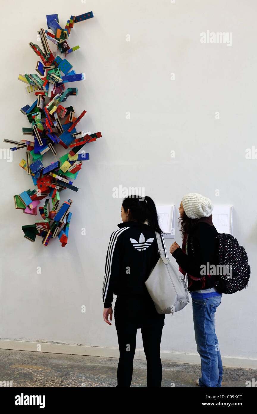 Two young women looking at a colorful work of art on the wall, tour Kunstakademie Art Academy in Duesseldorf Stock Photo