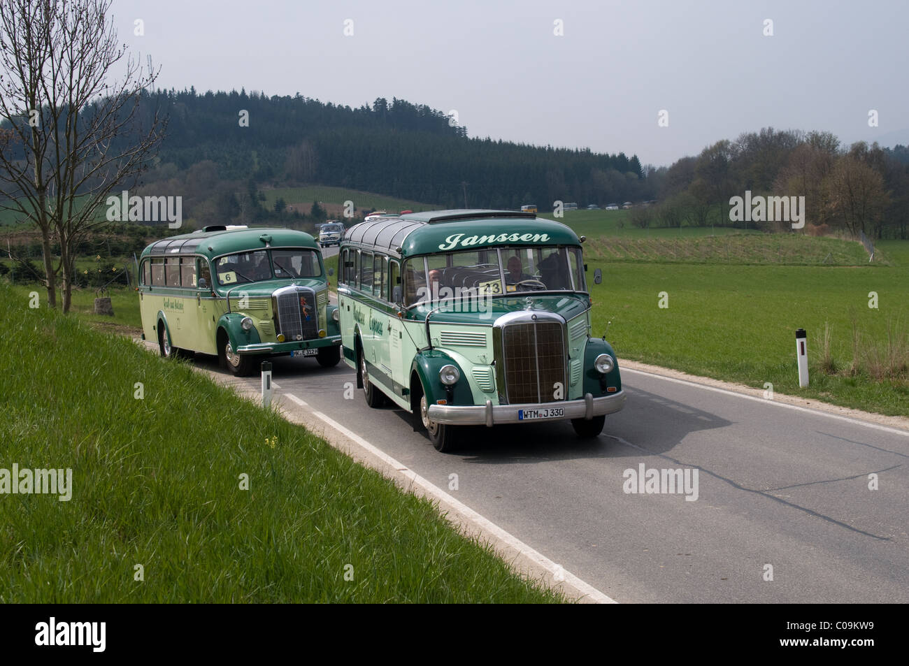 A pair of Mercedes-Benz O3500 take part in a road run for historic buses and coaches through the Austrian countryside. Stock Photo