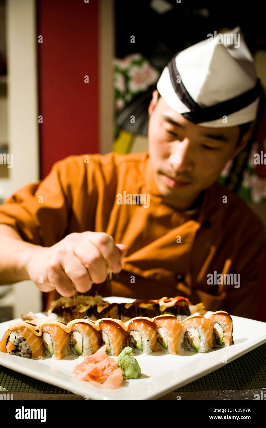 A chef prepares a plate of sushi. Stock Photo