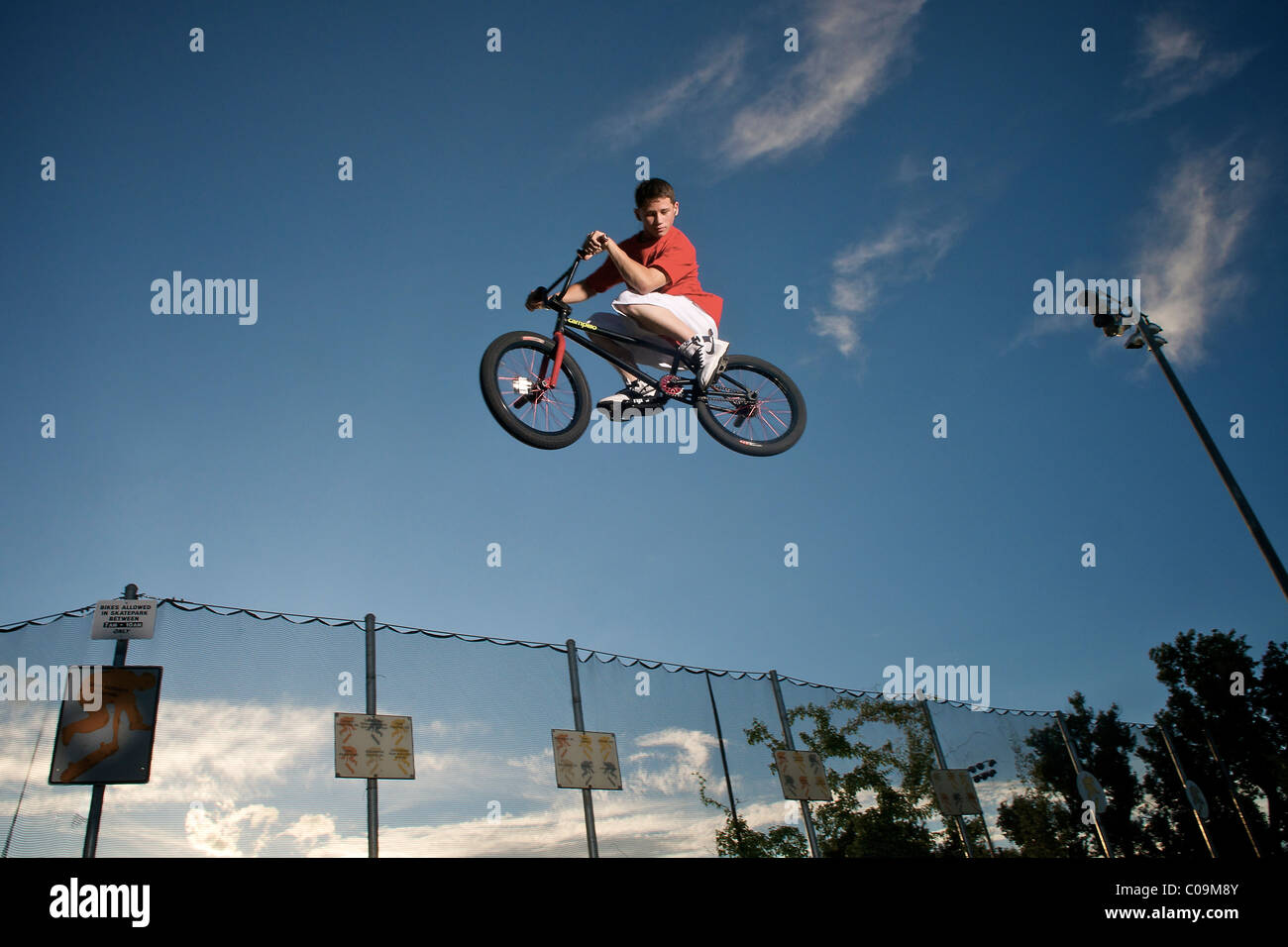 A male teen jumping on a bicycle. Stock Photo