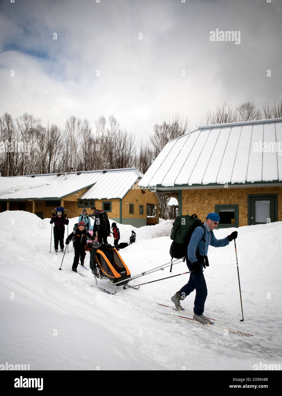 A family of cross country skiers leaving the Flagstaff Hut of Maine