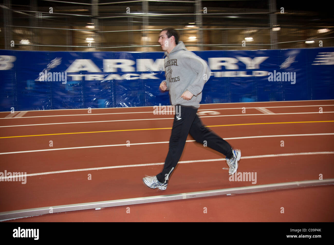Male college track and field athlete warming up prior to a competition