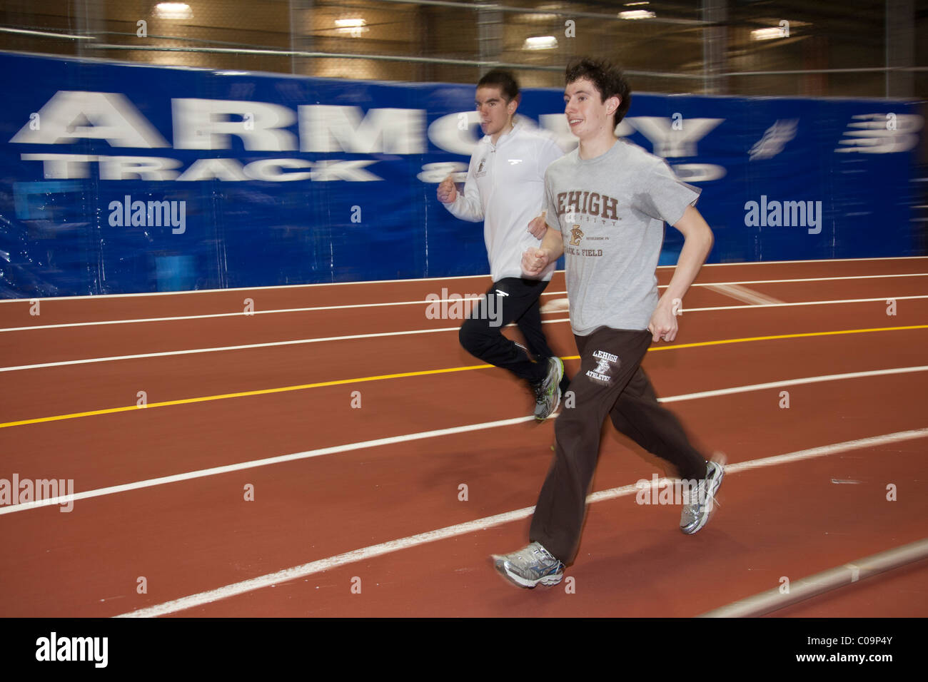 Male college track and field athletes warming up prior to a competition