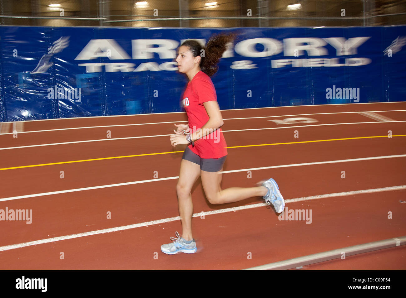 Female college track and field athletes warming up prior to a
