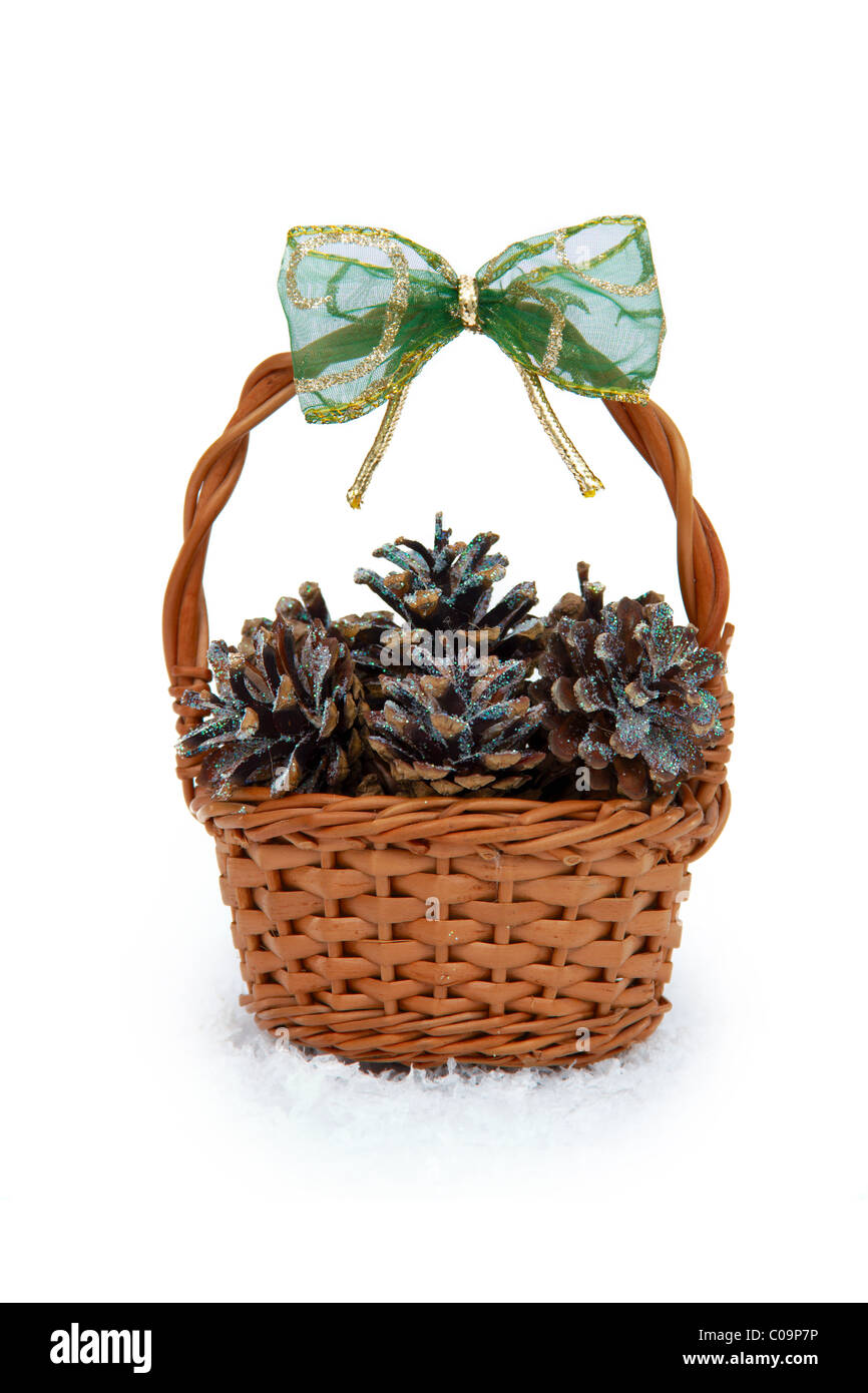 Basket with pine cones on a white background Stock Photo