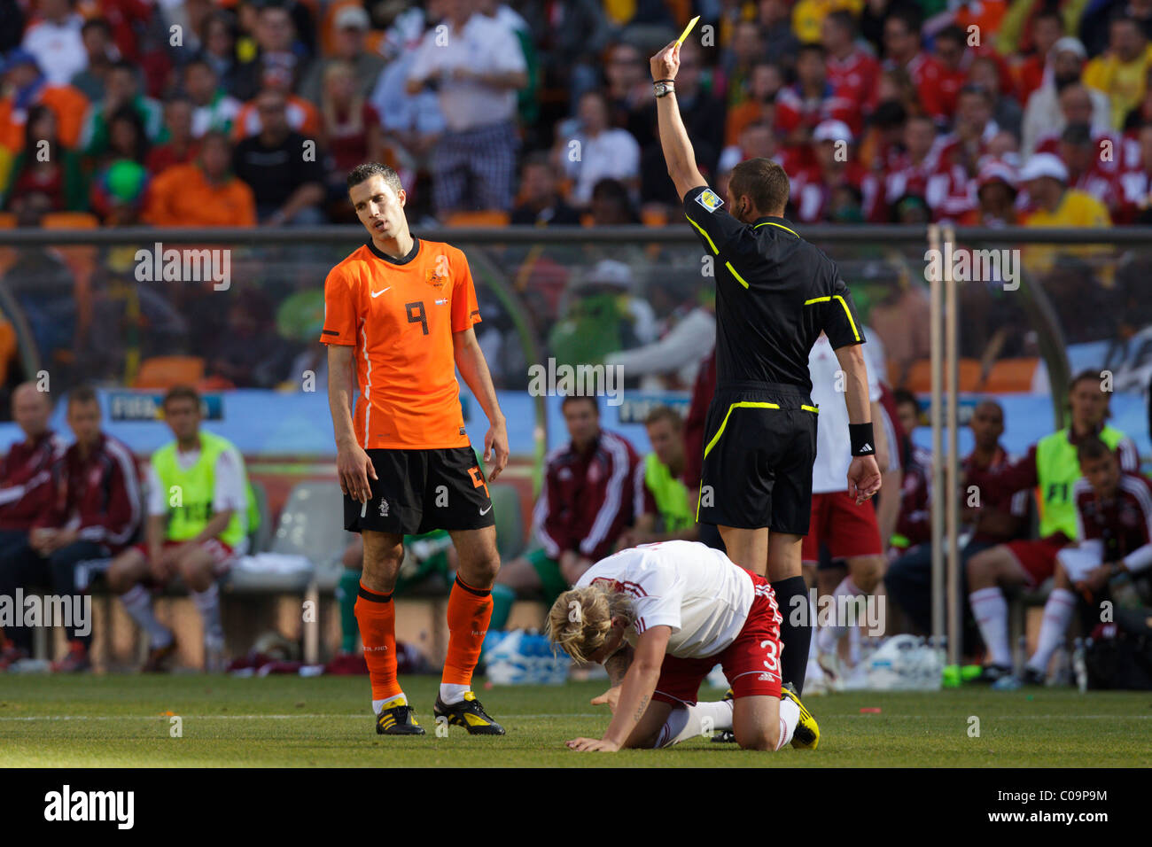 Robin van Persie of the Netherlands (9) reacts while being issued a yellow card caution during a 2010 World Cup match. Stock Photo