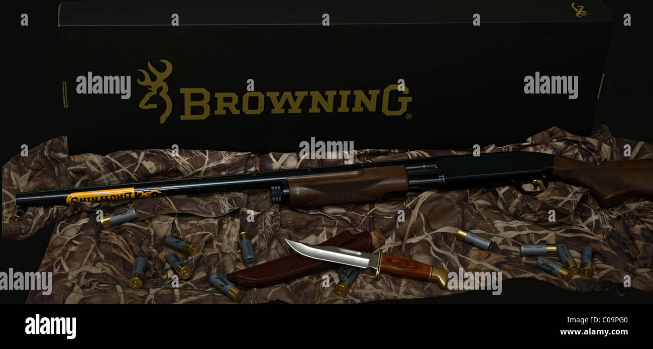 Browning BPS shotgun with shot shels and Buck Knife Stock Photo