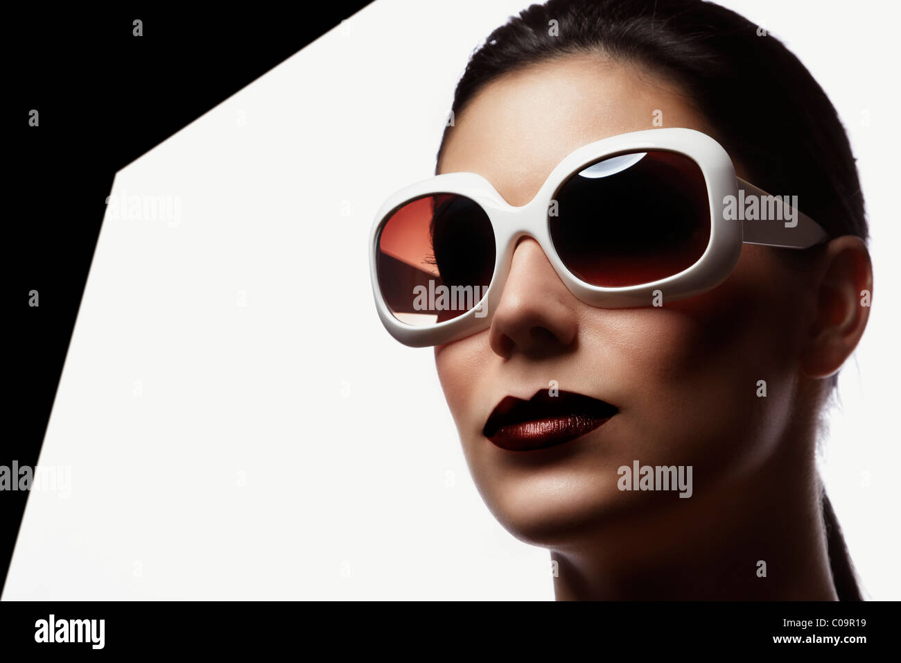 Young woman wearing white sunglasses, portrait Stock Photo Alamy