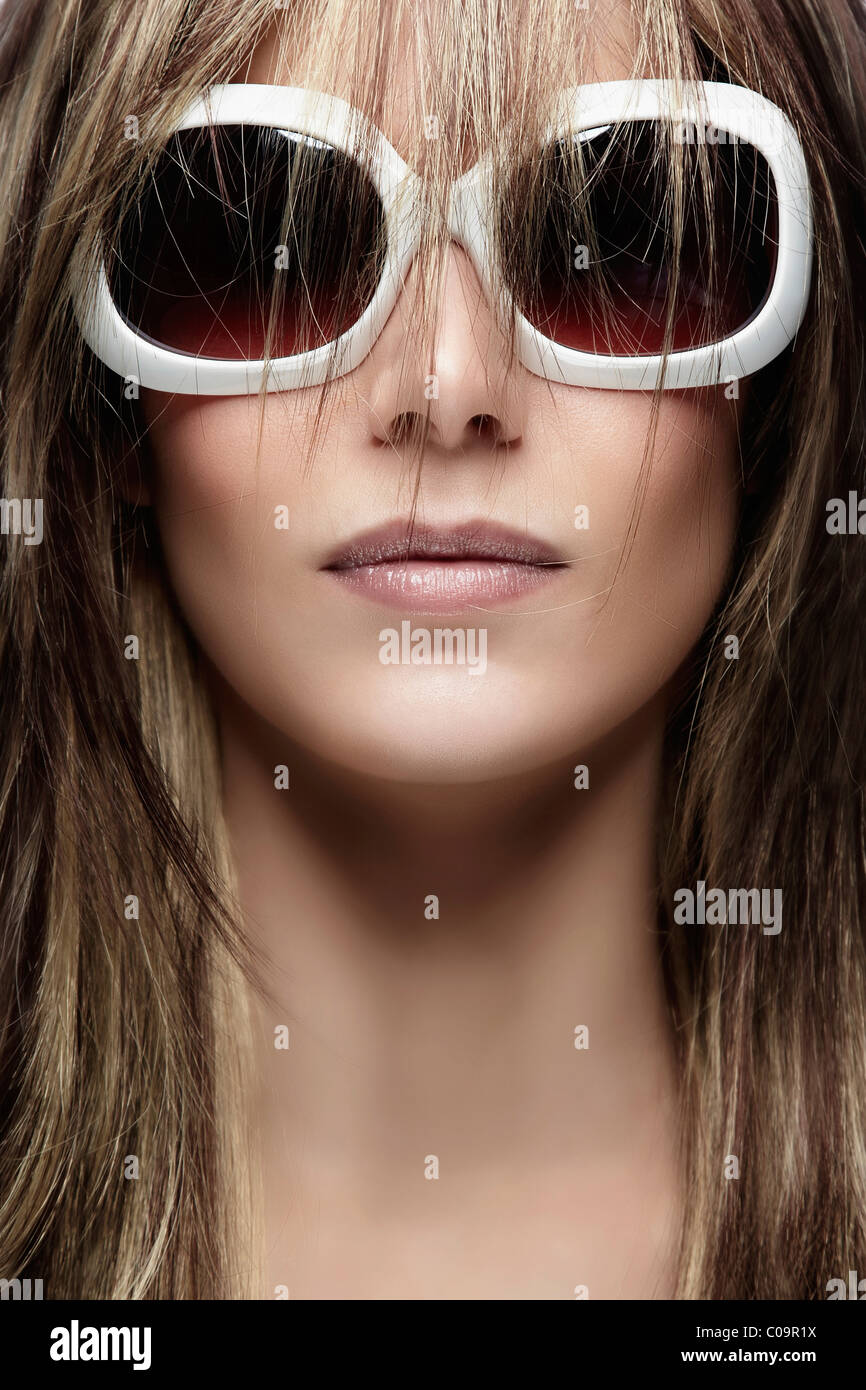 Young woman wearing white sunglasses, portrait Stock Photo Alamy
