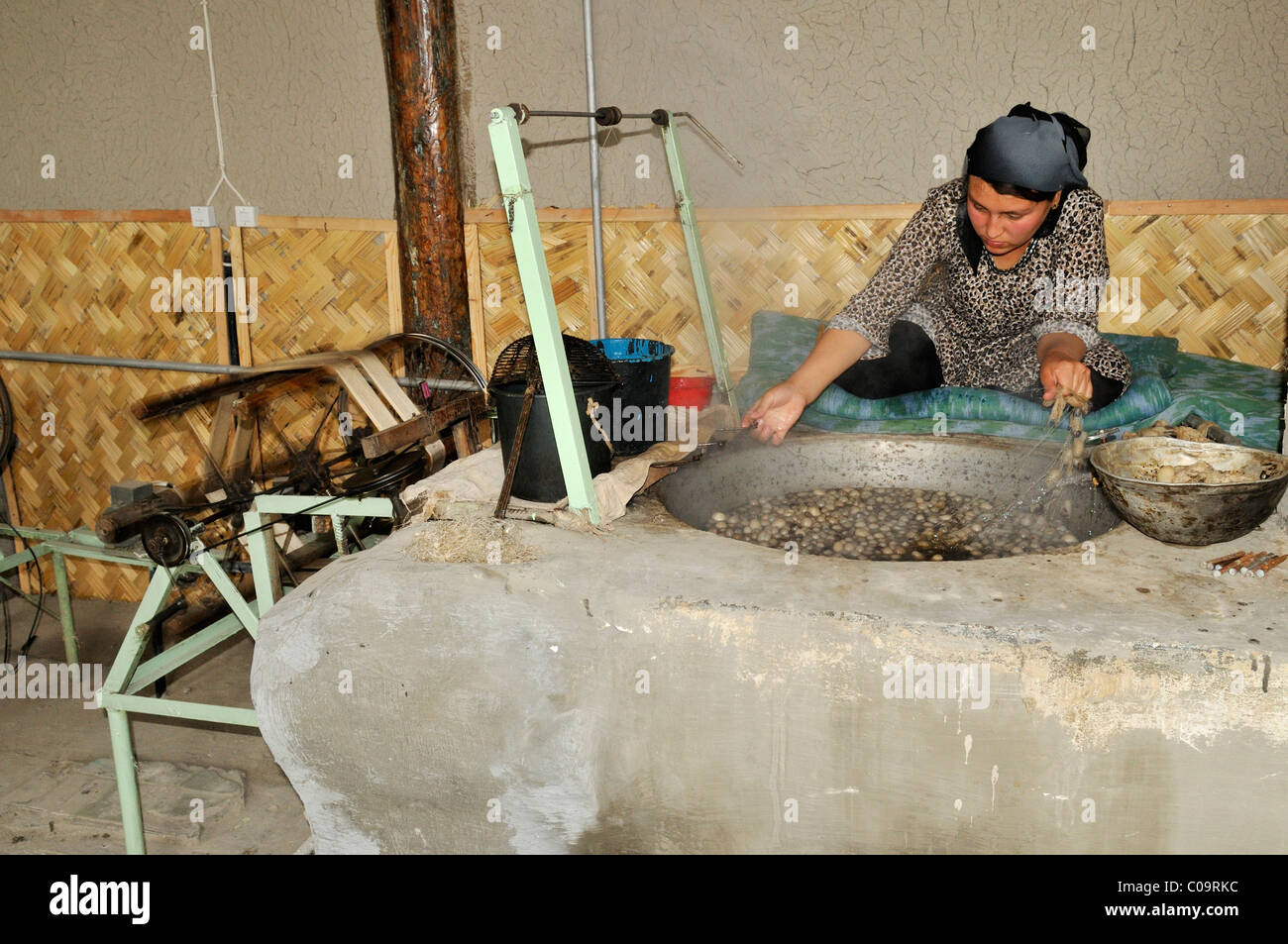 Silk production, Usbek woman cooking silkworm cocoons, Silk Road, Fergana Valley, Uzbekistan, Central Asia Stock Photo