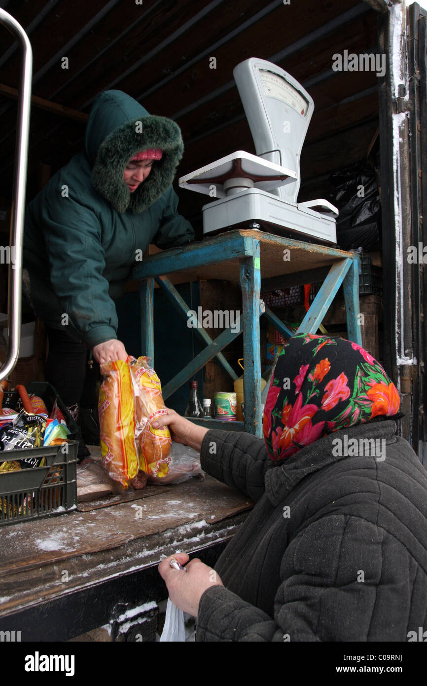 Village resident buys bread in the shop trailer in the shop trailer in the village Stock Photo
