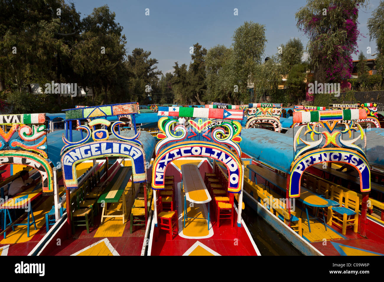 Colorful canal boats or trajineras await tourists at Xochimilco or 'the floating gardens' in southern Mexico City. Stock Photo