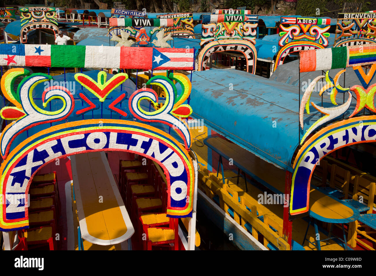 Colorful canal boats or trajineras await tourists at Xochimilco or 'the floating gardens' in southern Mexico City. Stock Photo