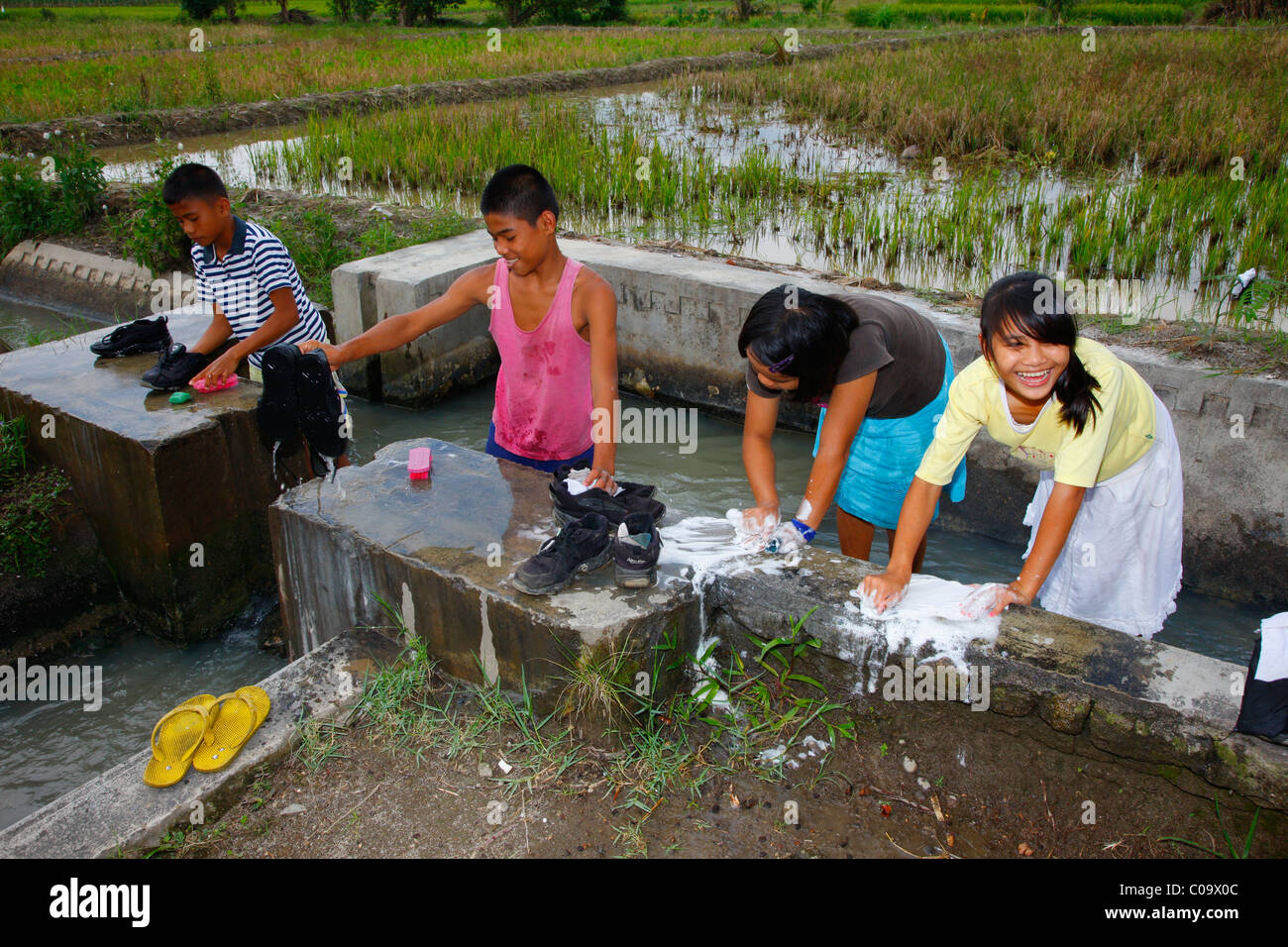 Children cleaning shoes and washing socks, Margaritha children's home, Marihat, Batak region, Sumatra island, Indonesia, Asia Stock Photo