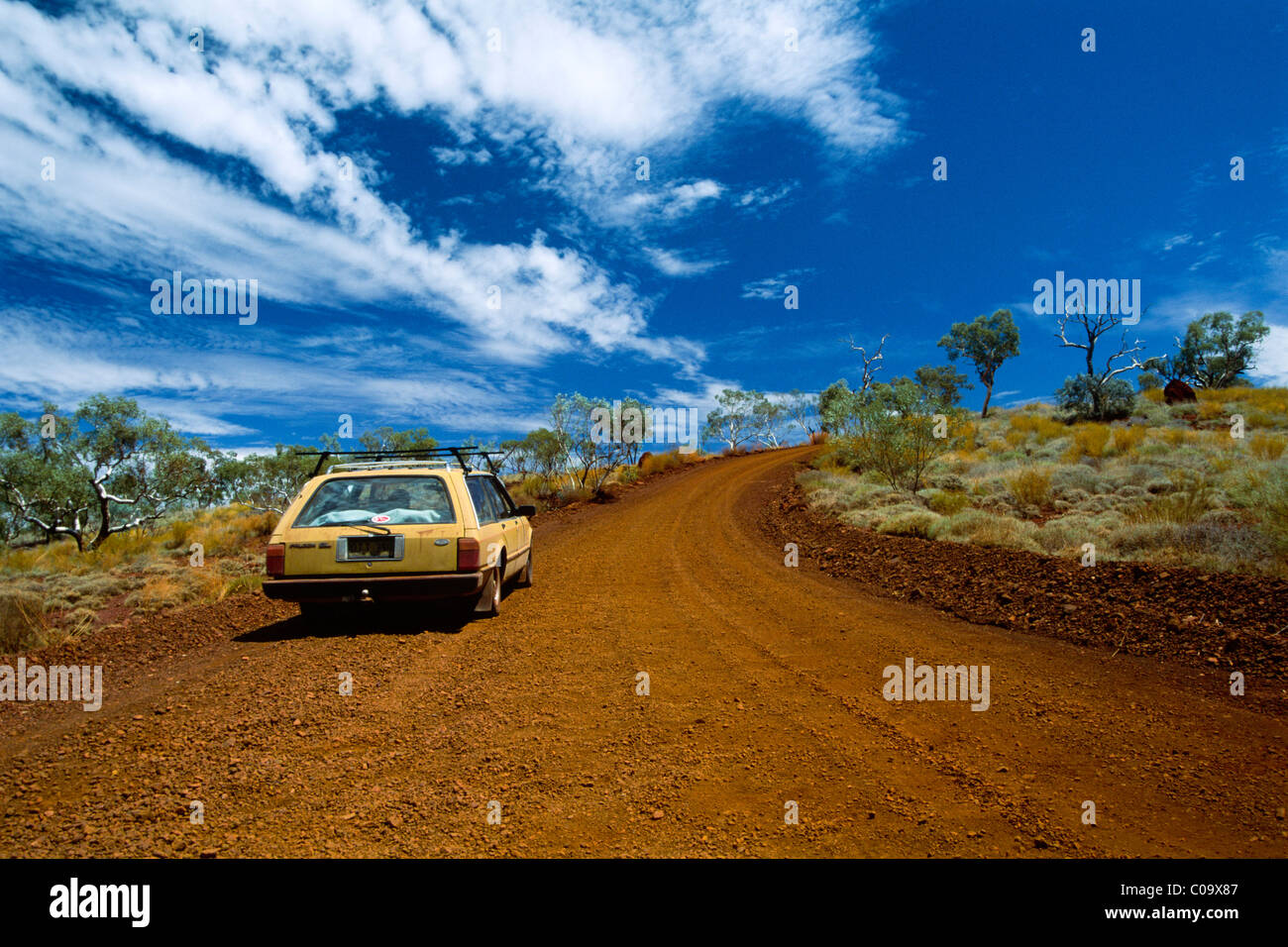 Car driving on a red dirt road in the Outback, Western Australia, Australia Stock Photo