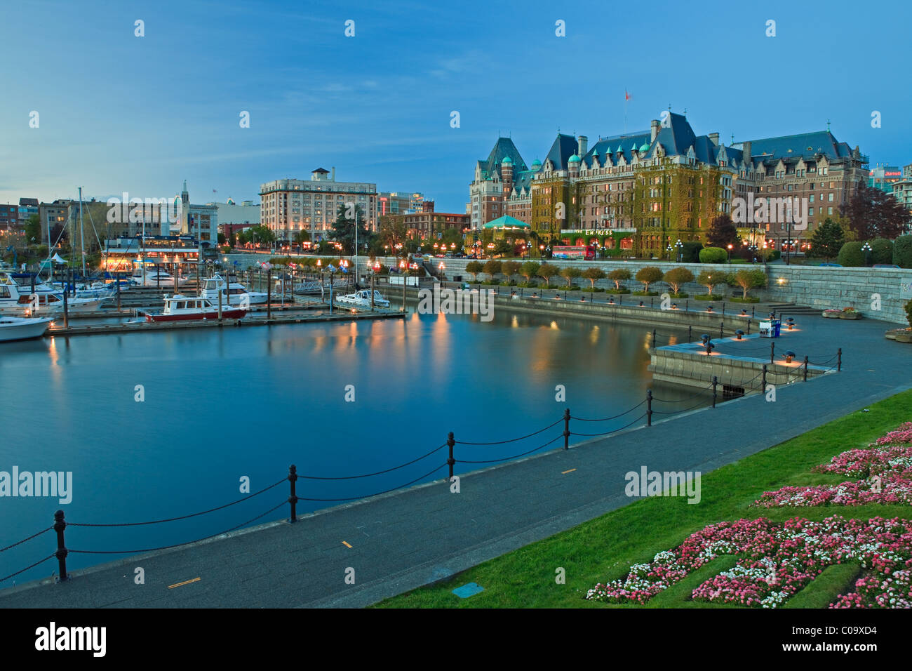Victoria's Inner Harbour with the landmark Empress Hotel (Fairmont Hotel) in the background at twilight, Victoria, Vancouver Isl Stock Photo