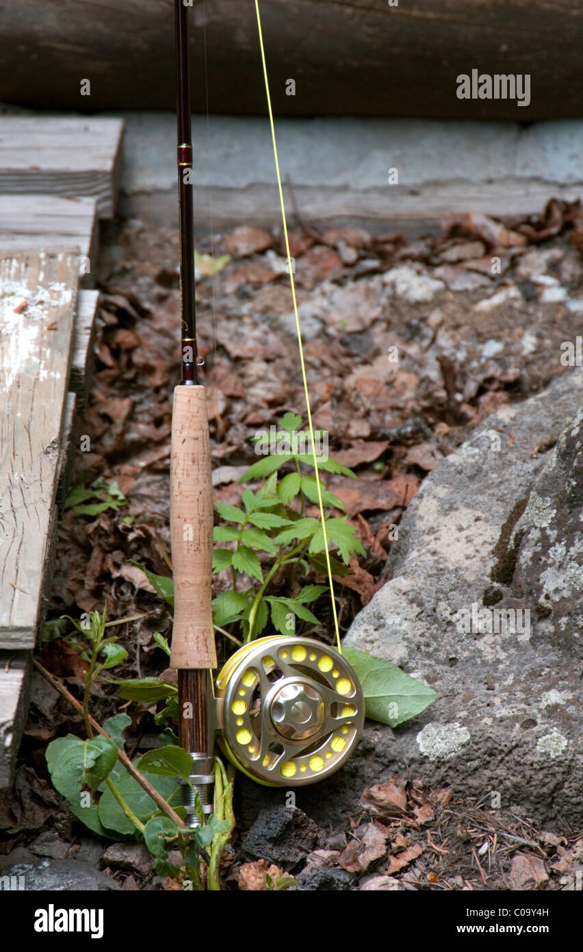 Fly fishing rod and reel propped near cabin Stock Photo - Alamy