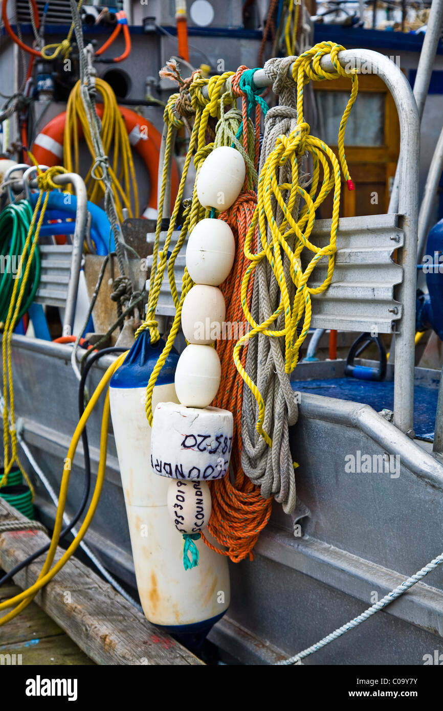 Abstract image of fishing boat equipment tied to a side rail of the boat Stock Photo