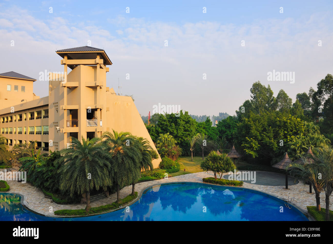 Large hotel and swimming pool in beautiful gardens in Guangzhou, China Stock Photo