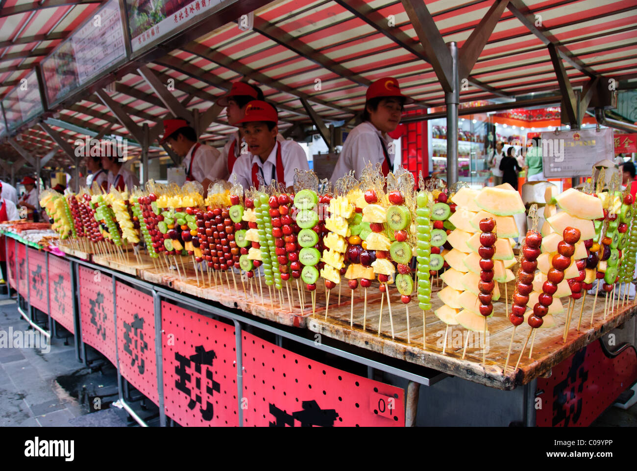Street vendors at a fruit stick stand Stock Photo Alamy
