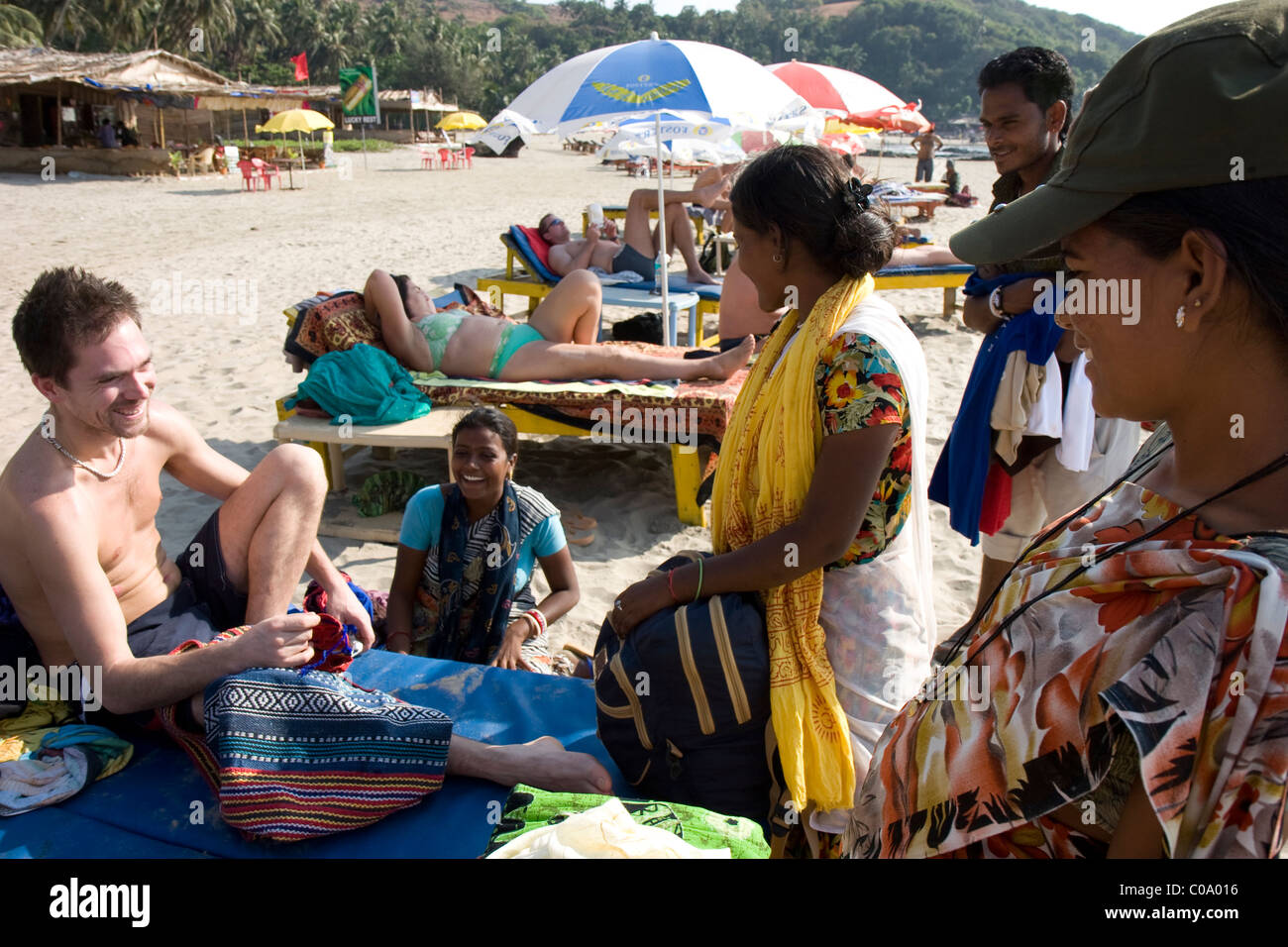 Tourist surrounded by Beach seller on Vagator beach in Goa Stock Photo