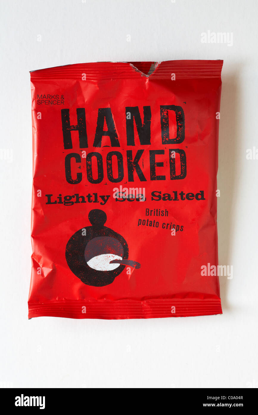 Empty packet of Marks & Spencer Hand Cooked Lightly Sea Salted British potato crisps isolated on white background Stock Photo