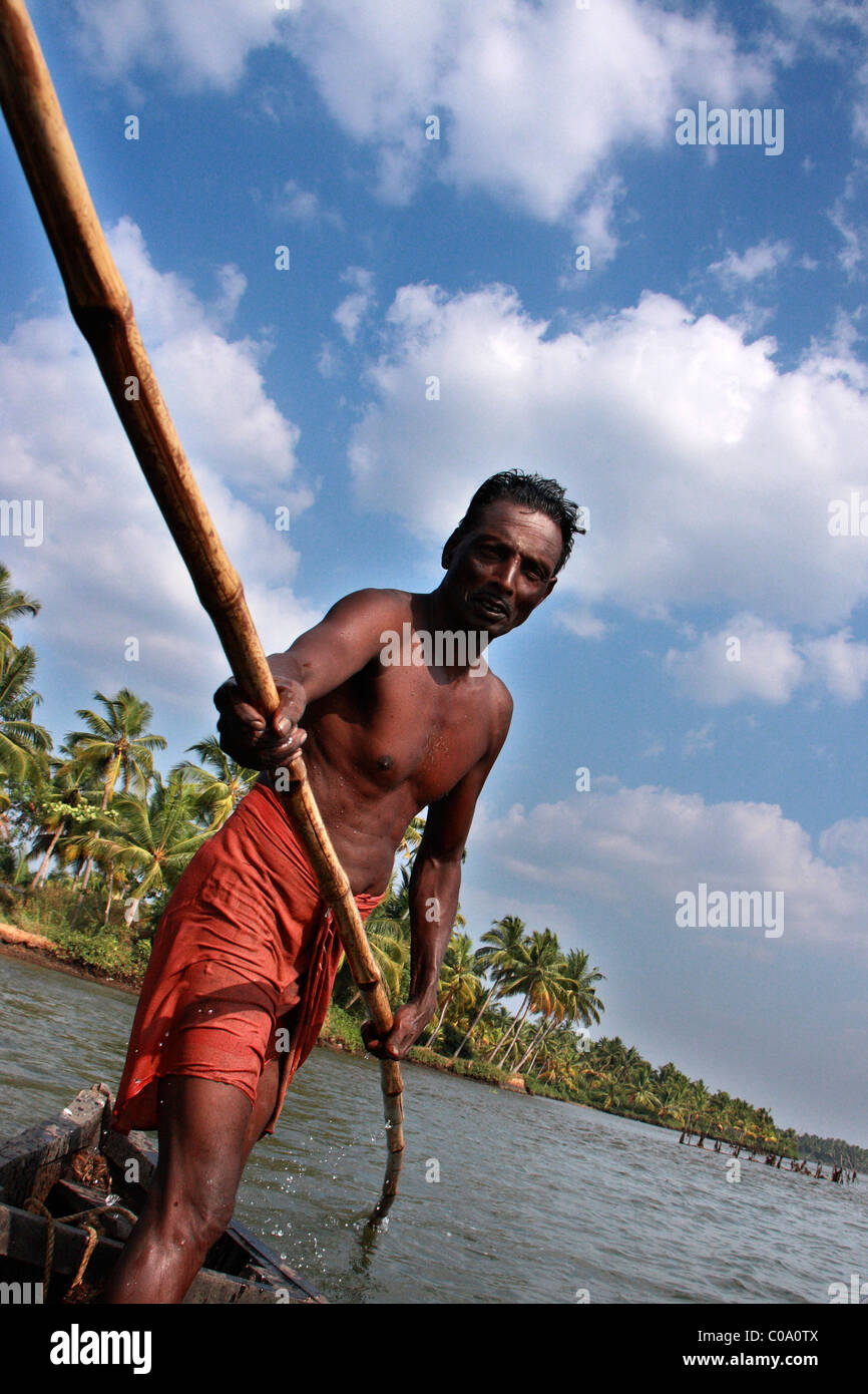 local village man sailing in a wooden boat in the back waters of kerala,india,asia Stock Photo