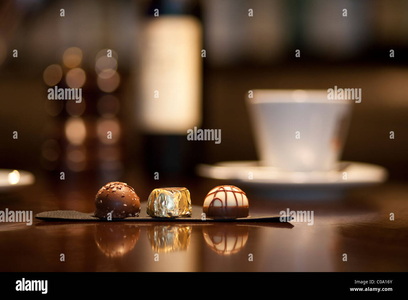 Luxury chocolates Truffle on a table with blurb coffee cup and wine in back ground Stock Photo