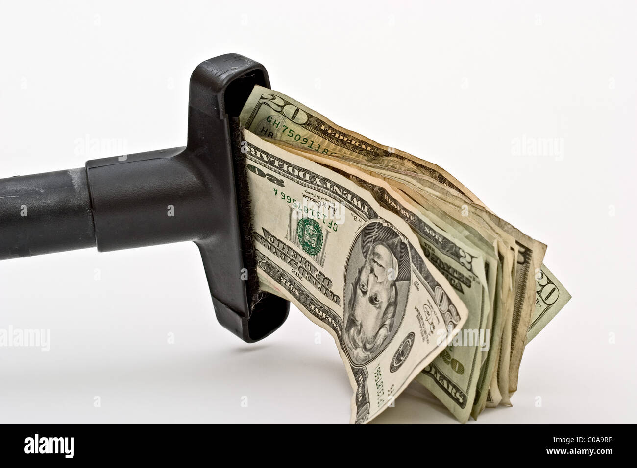 Cash being sucked into a vacuum cleaner Stock Photo