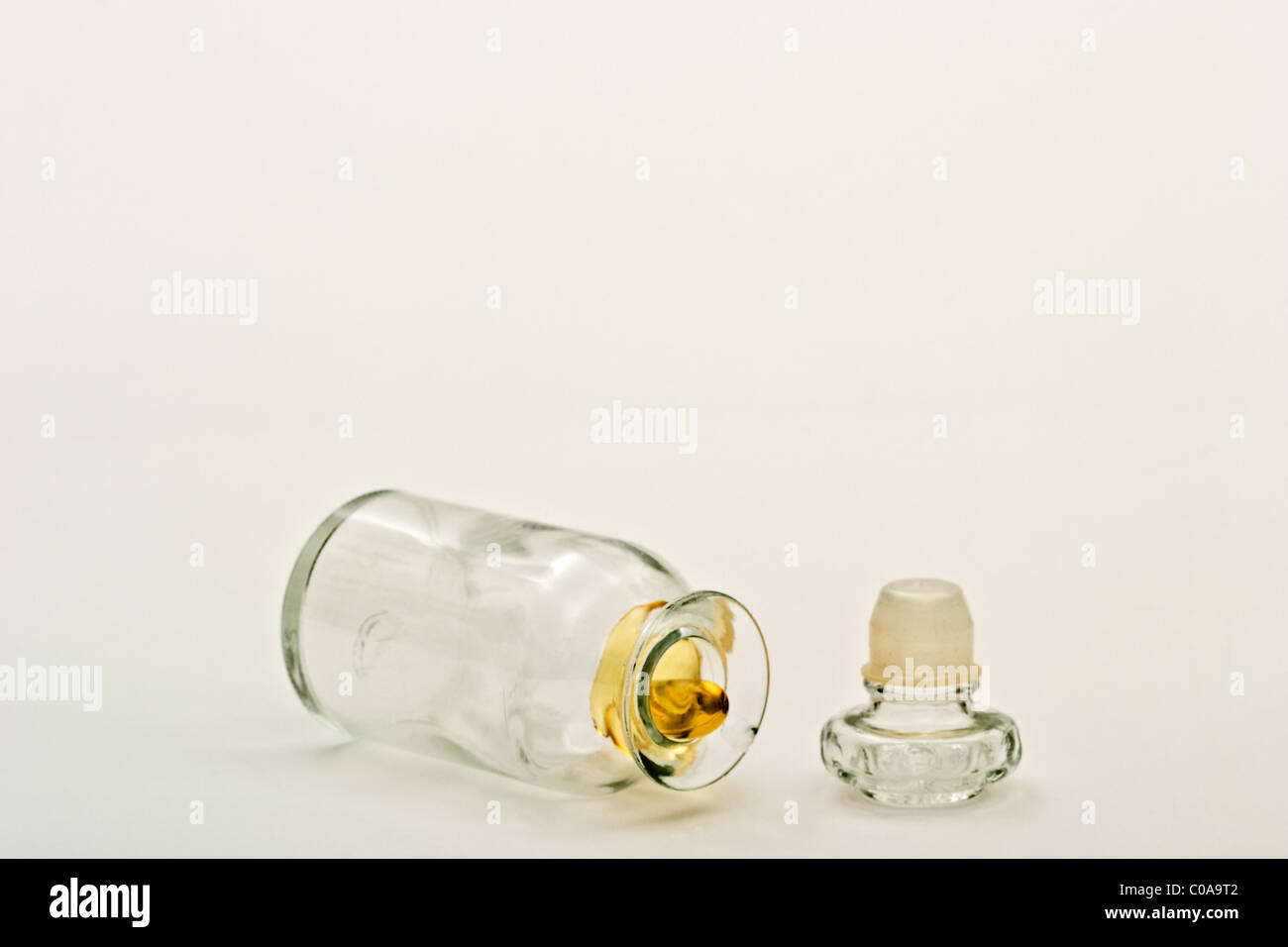 Single vitamin pill inside an old fashioned apothecary bottle with the cover off. Stock Photo
