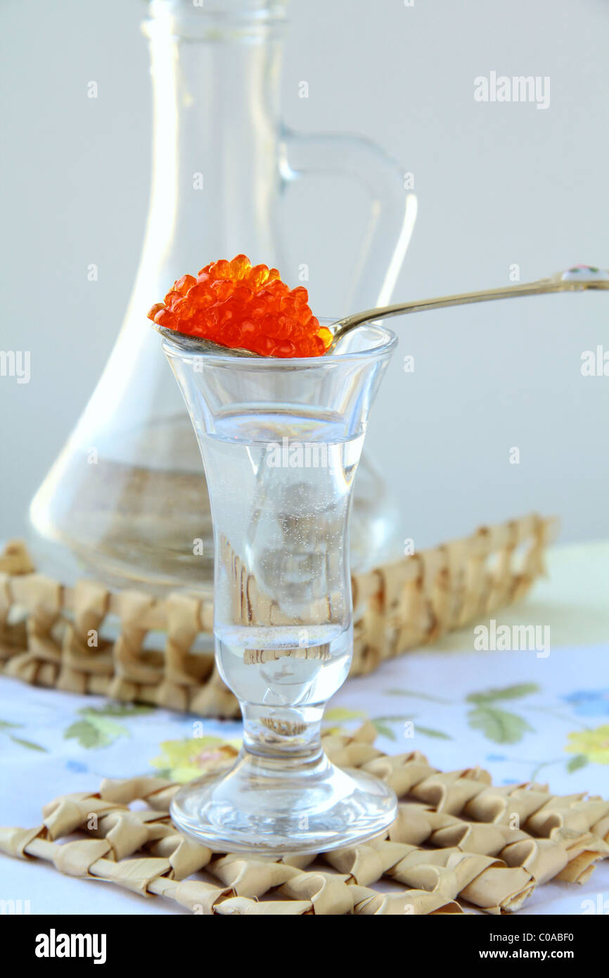 Russian vodka with a dollop of red caviar traditional appetizer Stock Photo