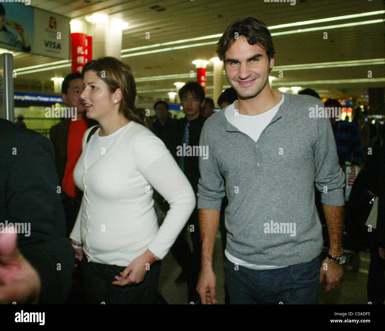 Tennis ace Roger Federer and his girlfriend and agent Mirka Vavrinec arrive at Shanghai International Airport for the Masters Stock Photo