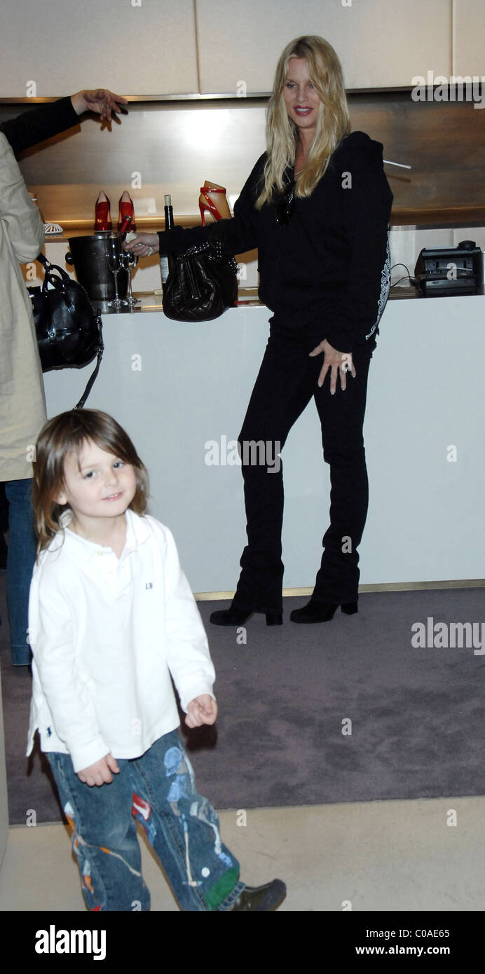 Nicollette Sheridan has her hands full as she shops for shoes with her friends and their child