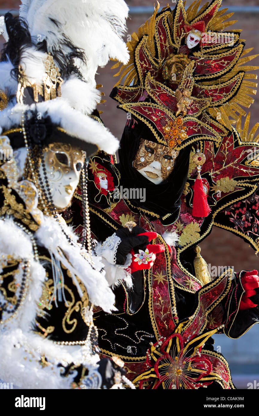 Two people in costume at the Venice Carnival Stock Photo - Alamy