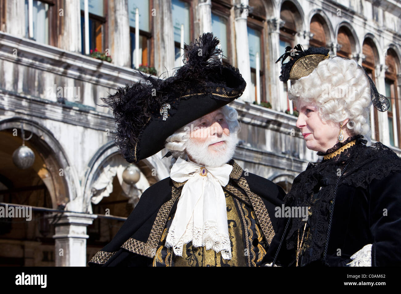 Two people in costume at the Venice Carnival Stock Photo - Alamy
