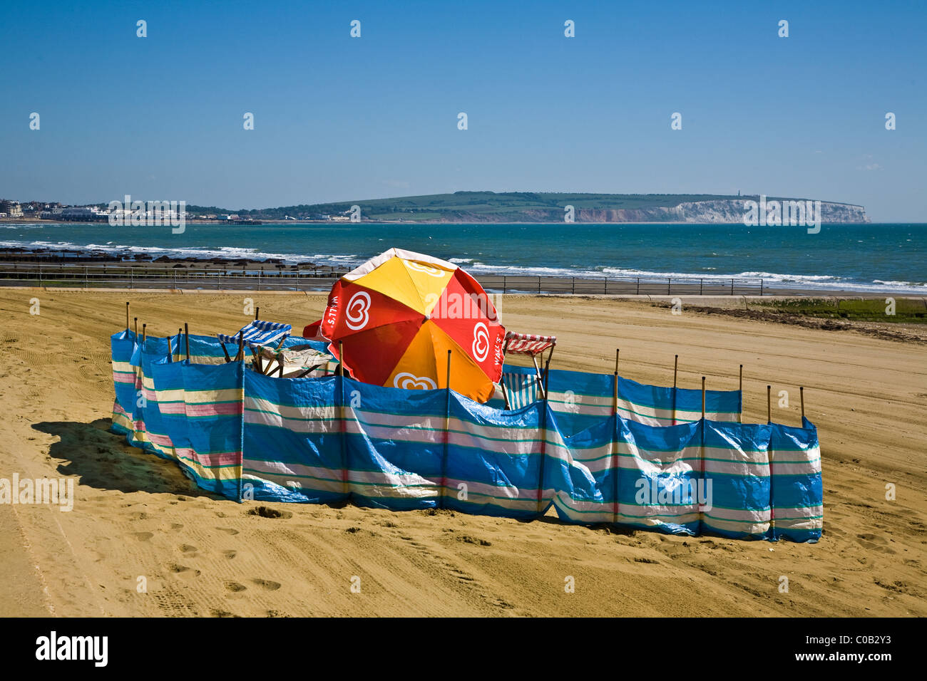 A wind break shelter set up on a beach in Shanklin on the Isle of Wight  Stock Photo - Alamy