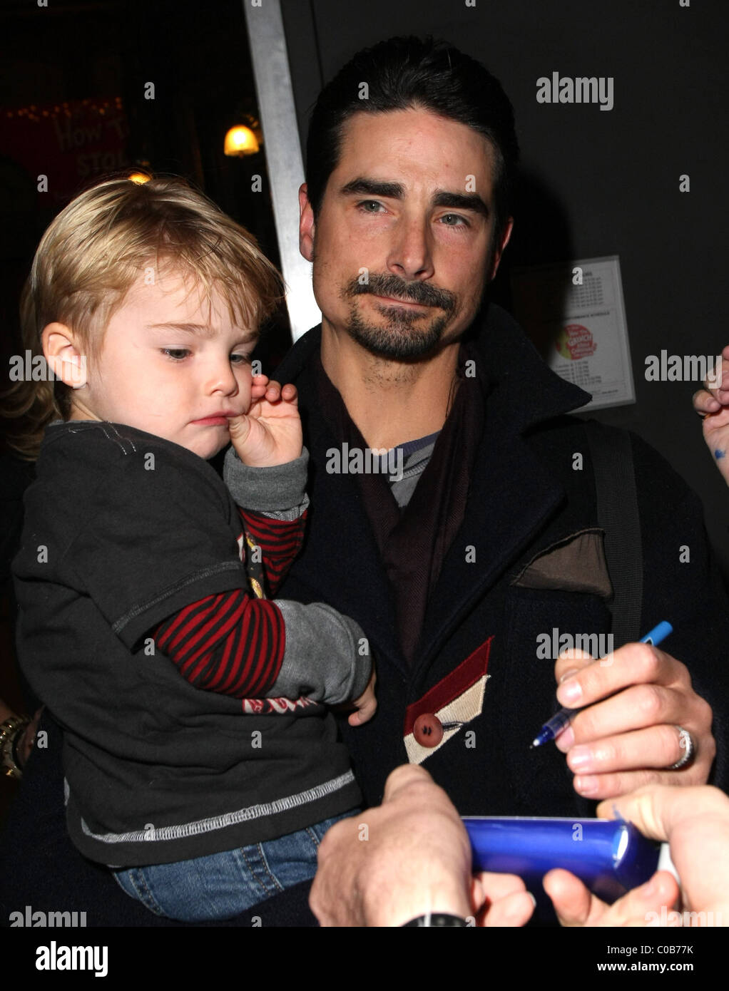 Kevin Richardson carries his son Mason as he leaves Pantages Theatre in  Hollywood after the opening of 'How the Grinch Stole Stock Photo - Alamy