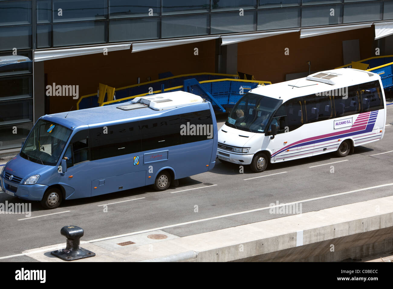 Modern Mini Buses Malaga Spain waiting on quayside for Cruise ship passengers Stock Photo