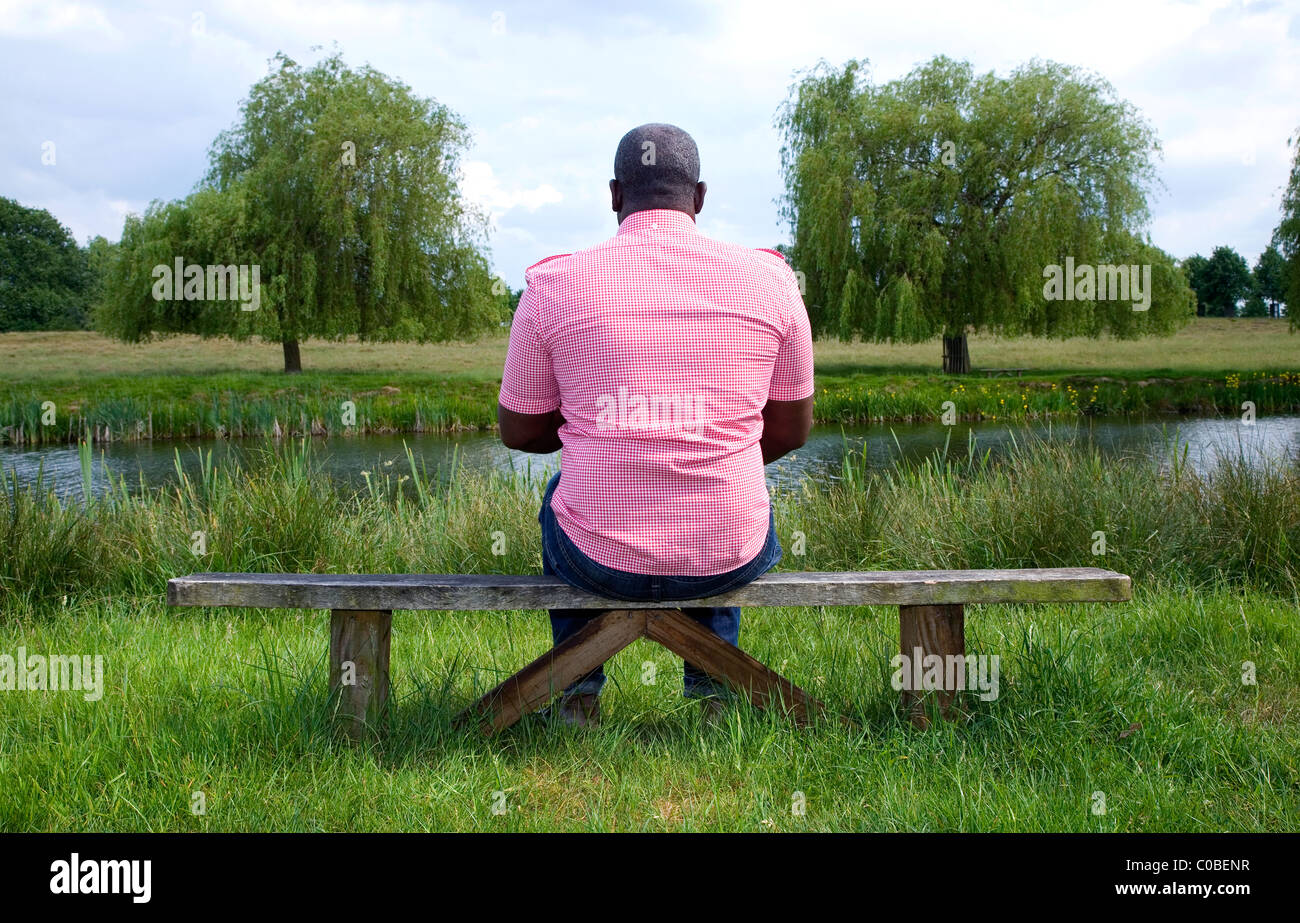 Colourful black man sitting on hi-res stock photography and images - Alamy