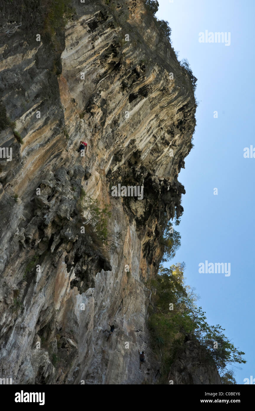 Panoramic view of Railay Beach peak with a rock climber on his way to
