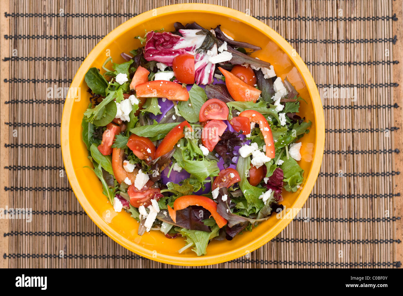 healthy organic salad in a colorful plastic bowl Stock Photo