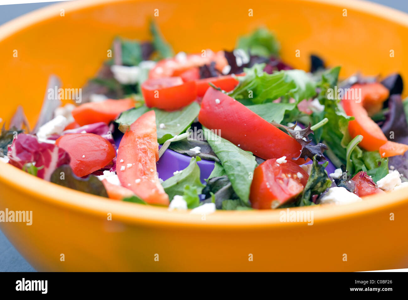 healthy organic salad in a colorful plastic bowl Stock Photo
